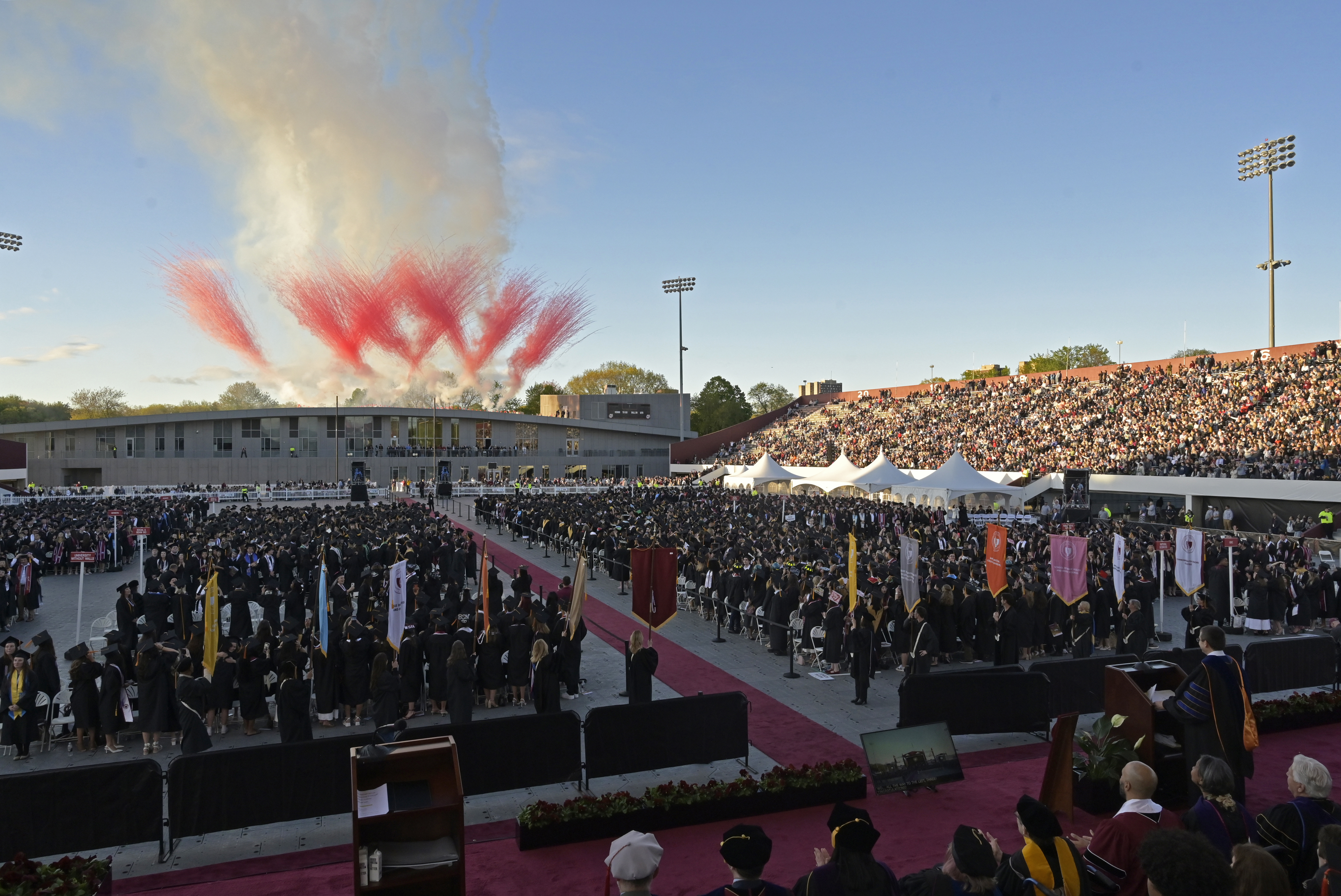 Pyrotechnics erupt over the Football Performance Center at the conclusion of the 2026 UMass Amherst Undergraduate Commencement Ceremony